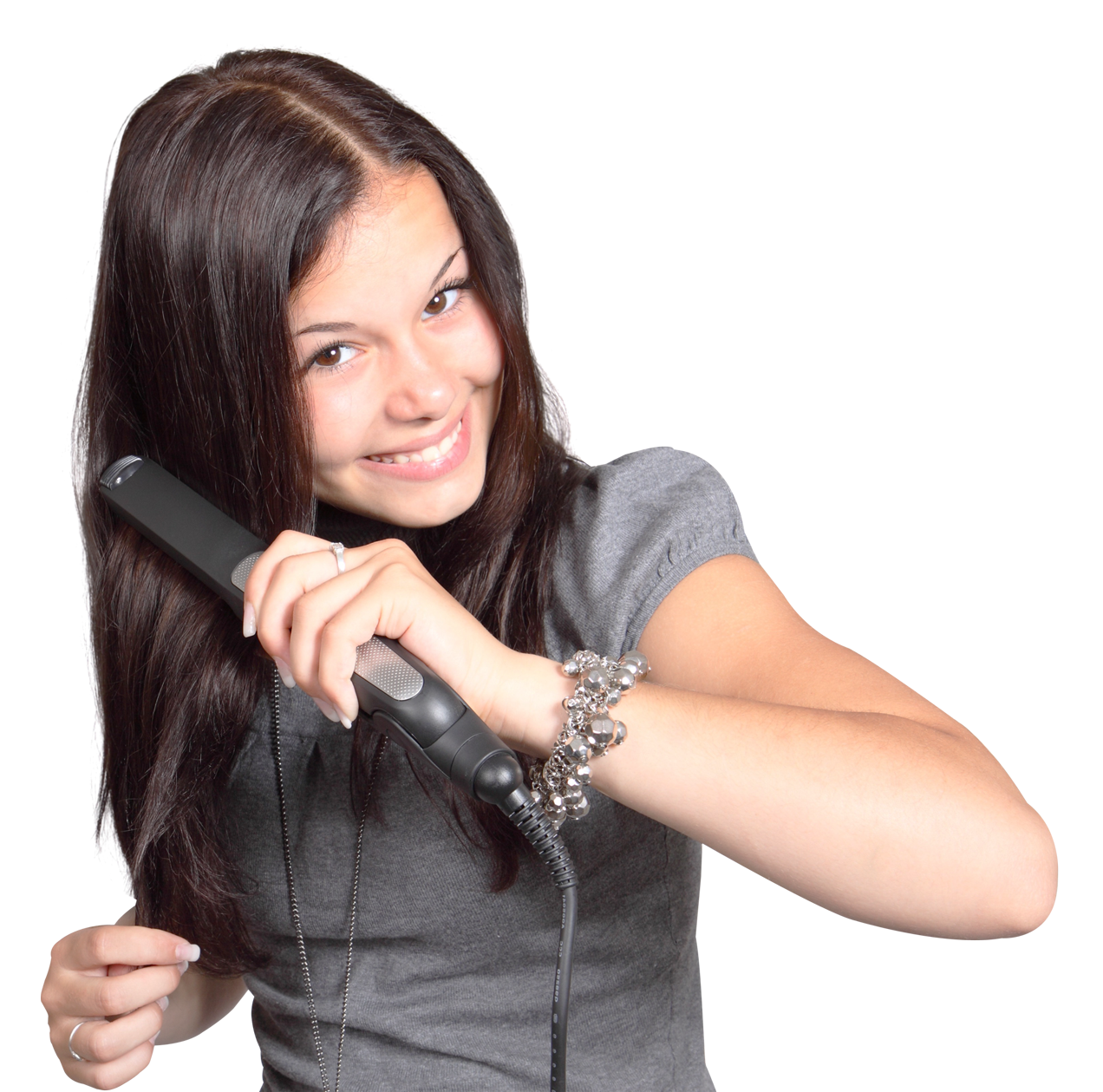 Happy Teen Girl Styling Hairwith Flat Iron