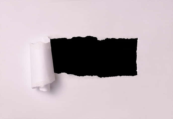 Ripped Paper Revealing Black Background.jpg