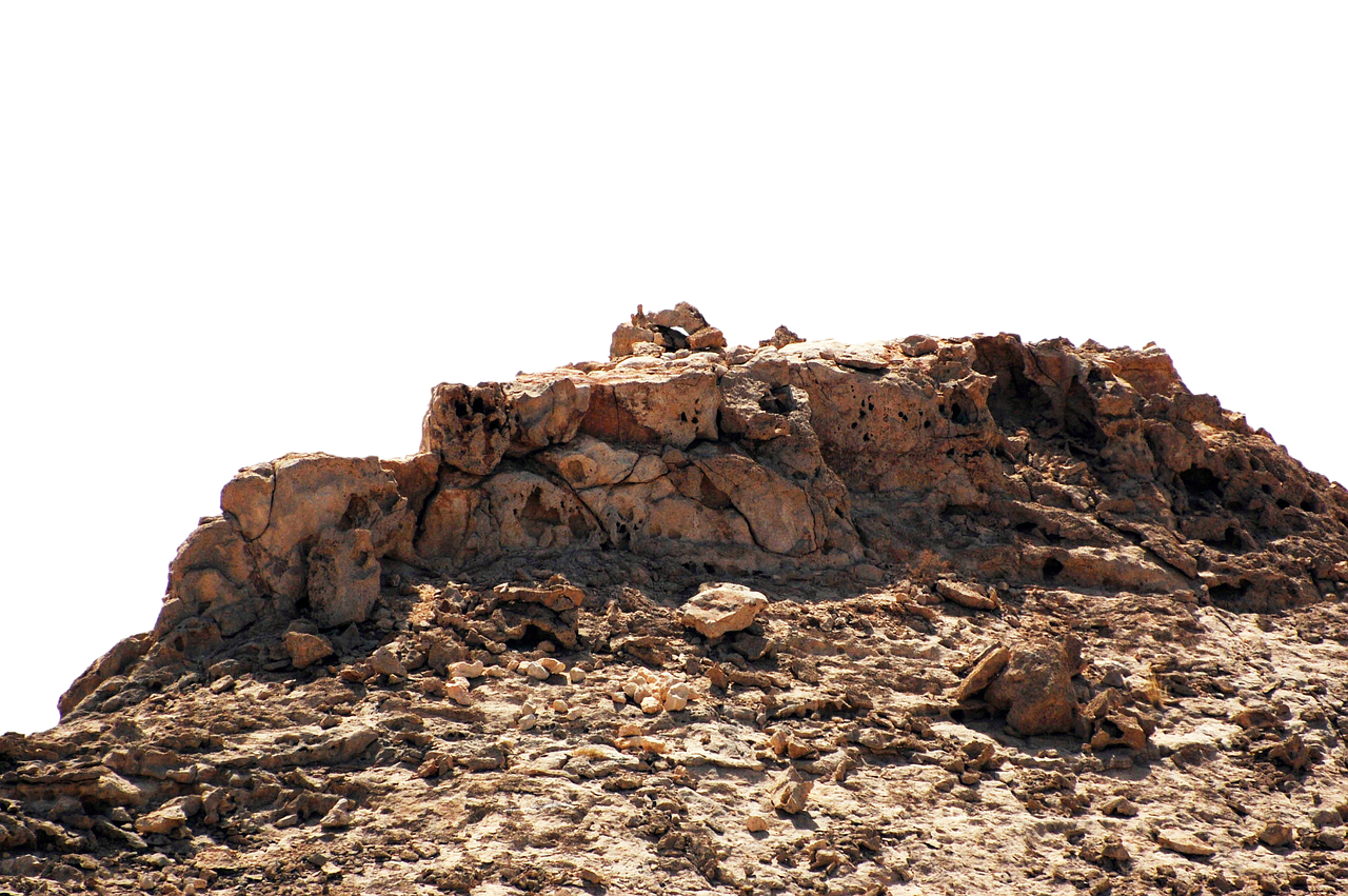 Rocky_ Outcrop_ Against_ Dark_ Background.jpg PNG with transparent background
