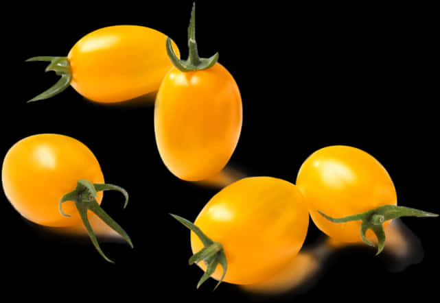 Yellow Cherry Tomatoeson Black Background