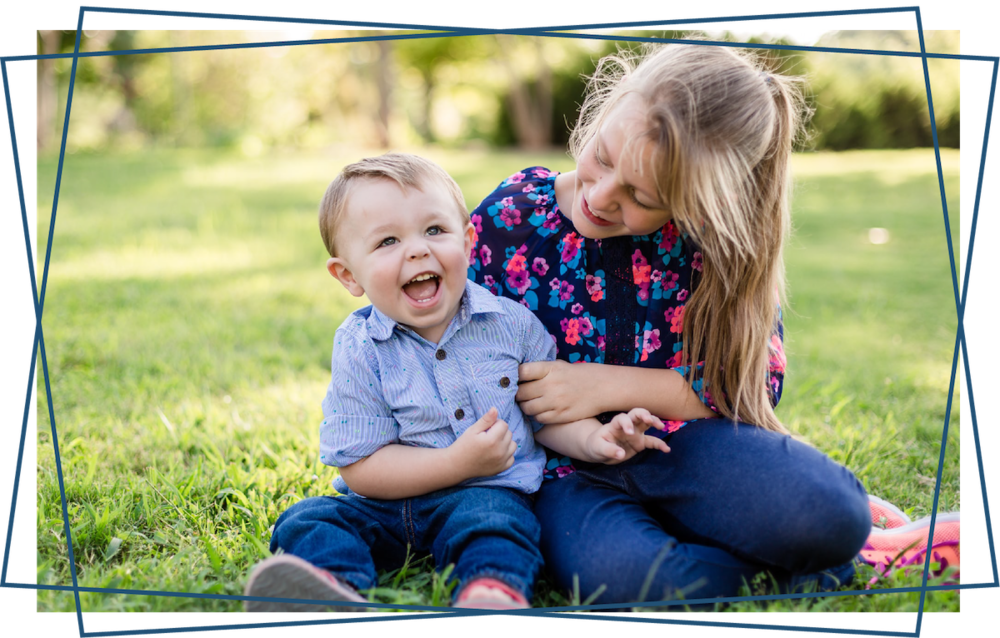 Joyful Siblings Playing Outdoors PNG Image