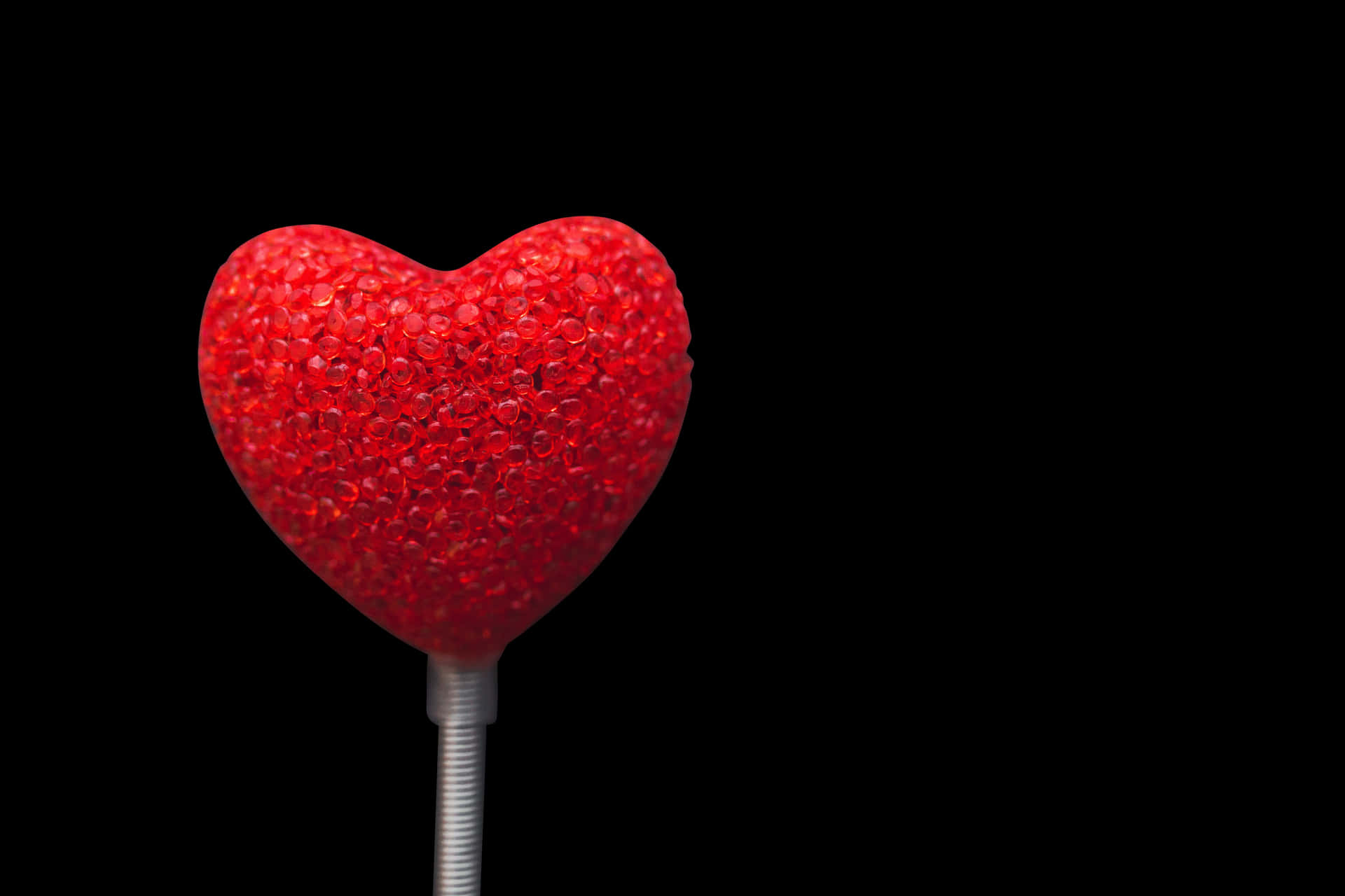 Red Sparkling Hearton Black Background PNG Image