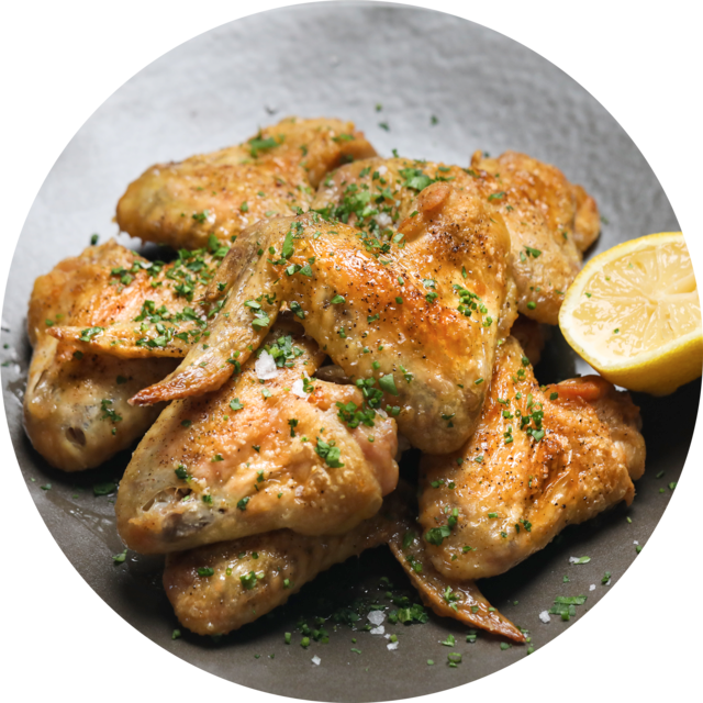 Seasoned Chicken Wingswith Lemon Garnish PNG Image