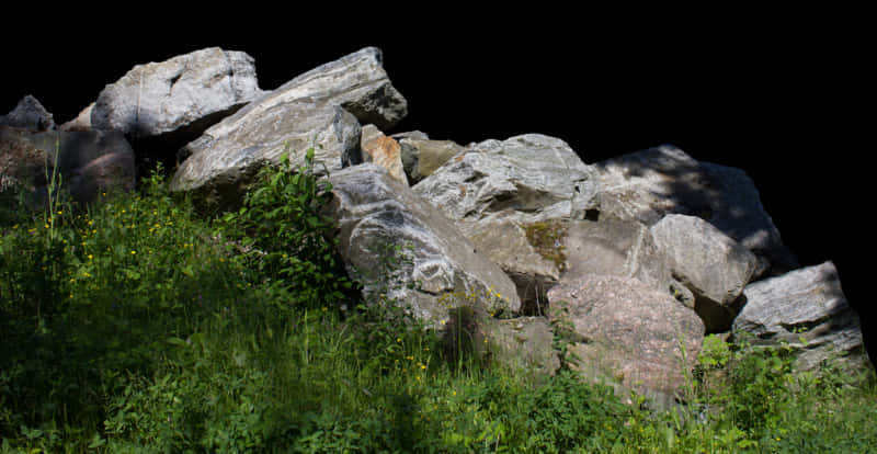 Sunlit Boulders Grassy Foreground PNG Image