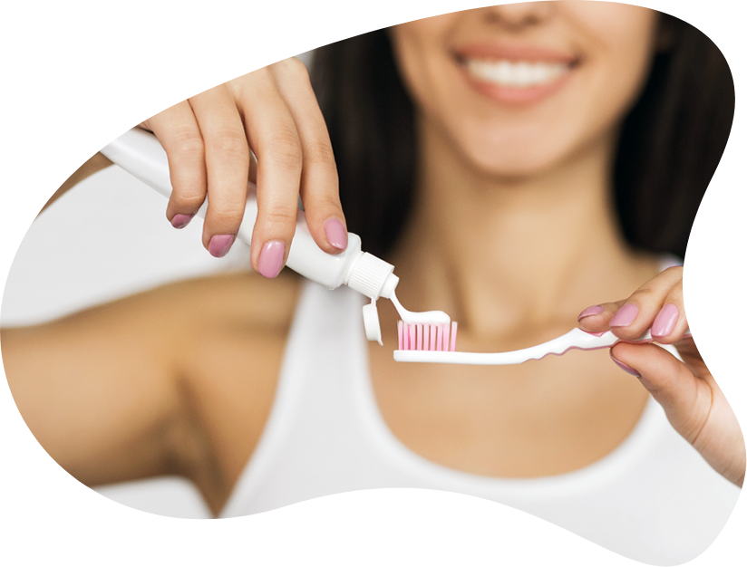 Woman_ Applying_ Toothpaste_ On_ Toothbrush PNG Image