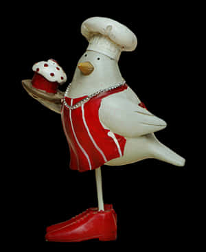 Chef Bird Figurinewith Cupcake PNG image with transparent background