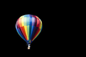 Colorful Hot Air Balloon Against Black Background PNG image with transparent background