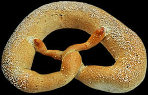 Golden Baked Pretzel Black Background PNG with transparent background