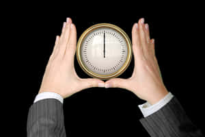 Hands Holding Clock Against Black Background PNG image with transparent background