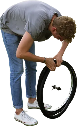 Man Repairing Bicycle Tire PNG Image