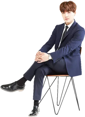 Manin Blue Suit Seated PNG Image