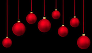 Red Christmas Ornaments Hanging Against Black Background.jpg PNG image with transparent background