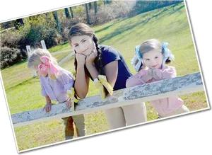 Three Girls Leaningon Fence Outdoors PNG Image