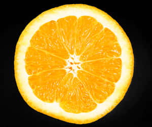 Vibrant Orange Slice Against Black Background PNG image with transparent background